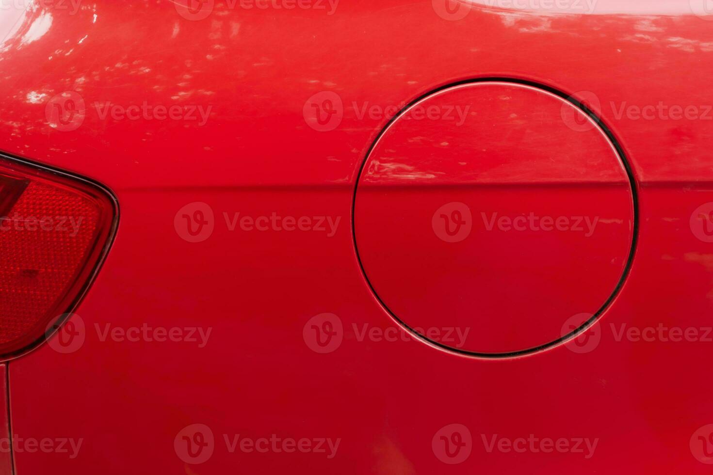 Close-up of the round fuel tank cap of a red car. photo