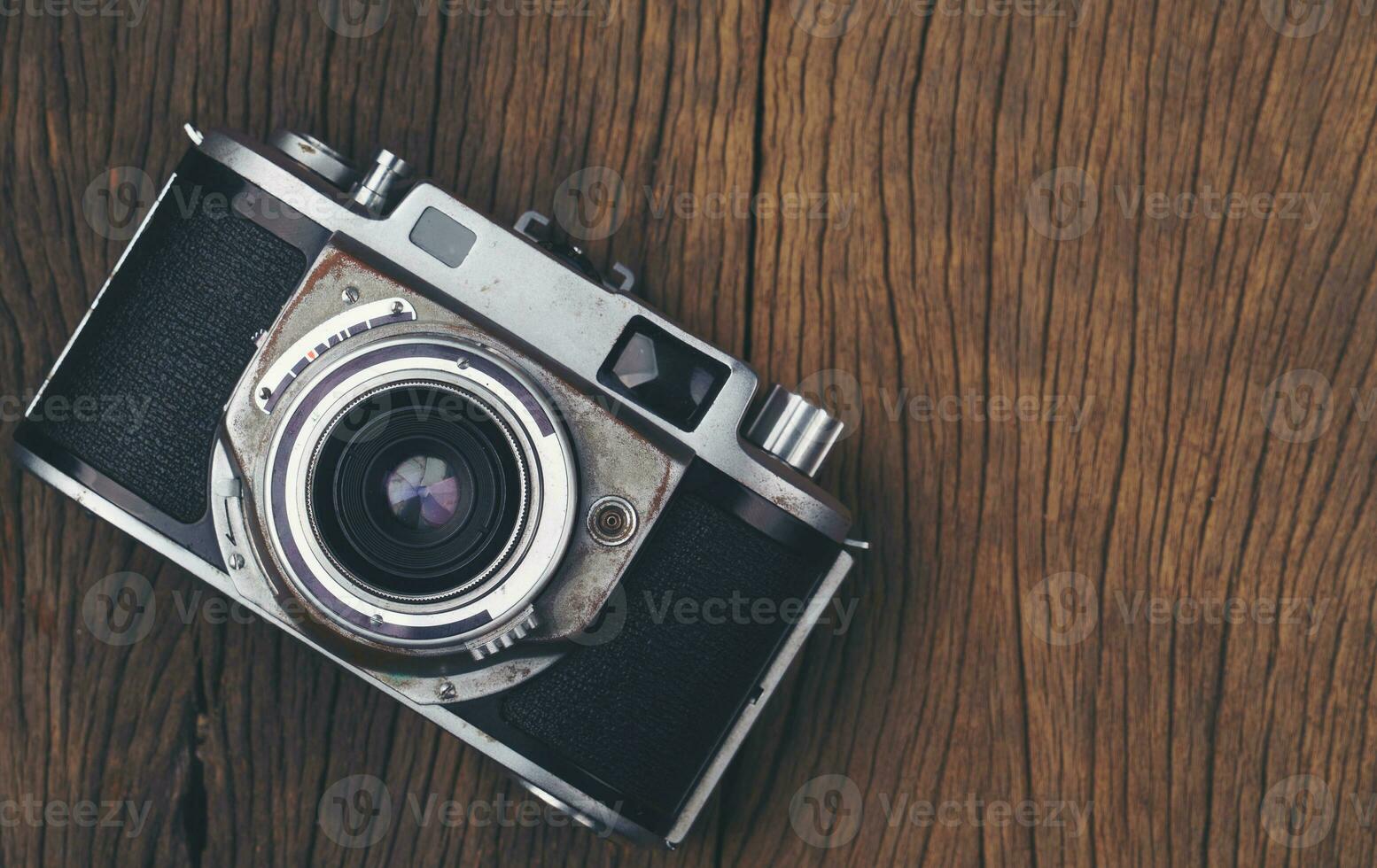 vintage old film camera on wood board photo