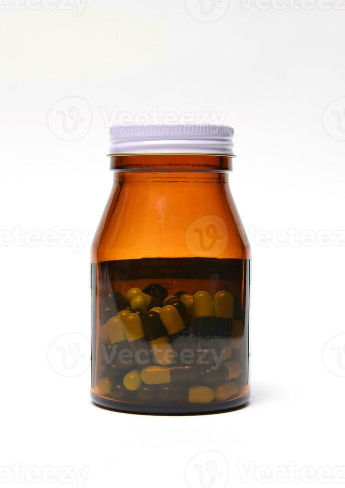 group of green capsule medicine in bottle photo