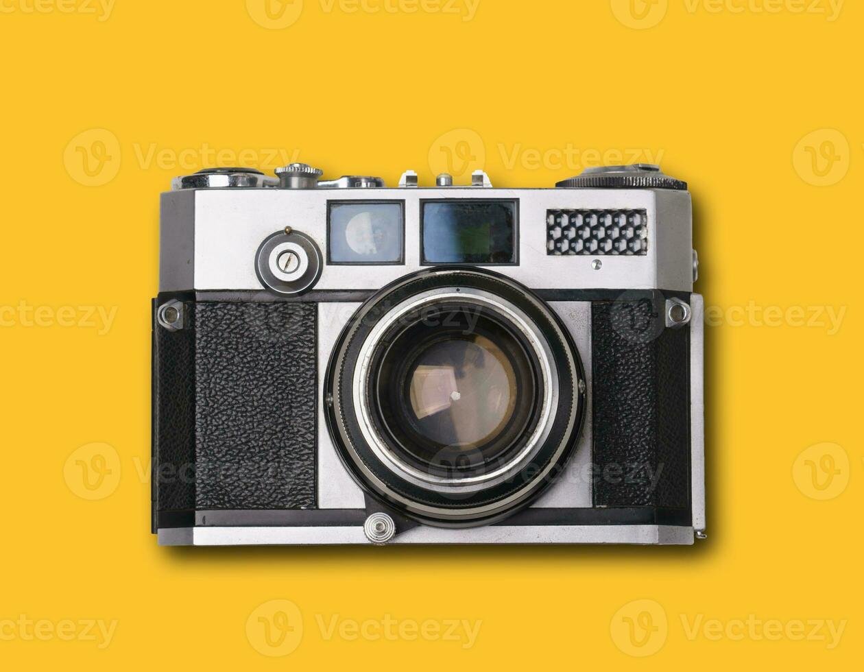 vintage old film camera on yellow background photo