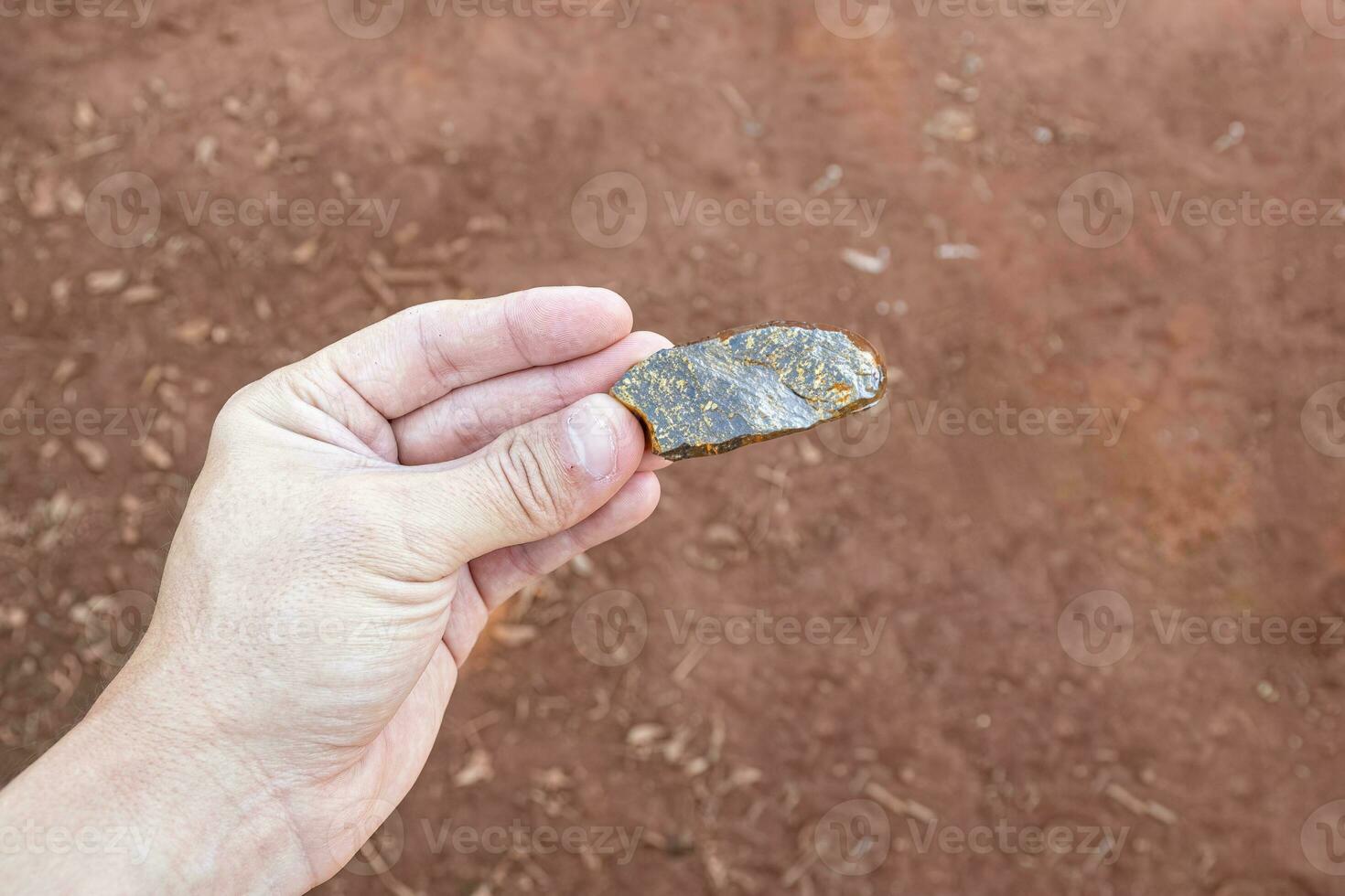 hand holding piece of gold ore photo
