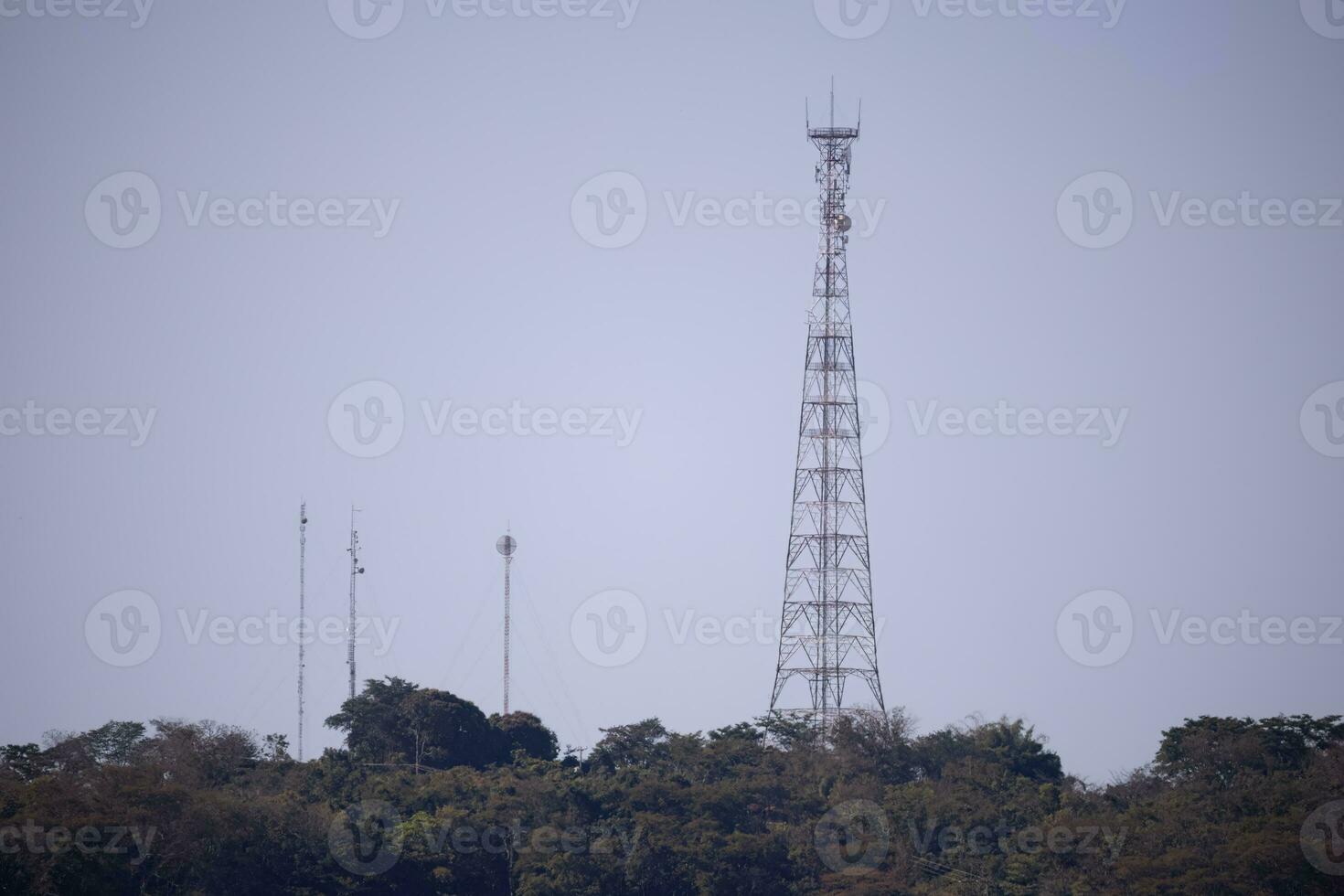 Metal telecommunication tower on top of a mountain photo