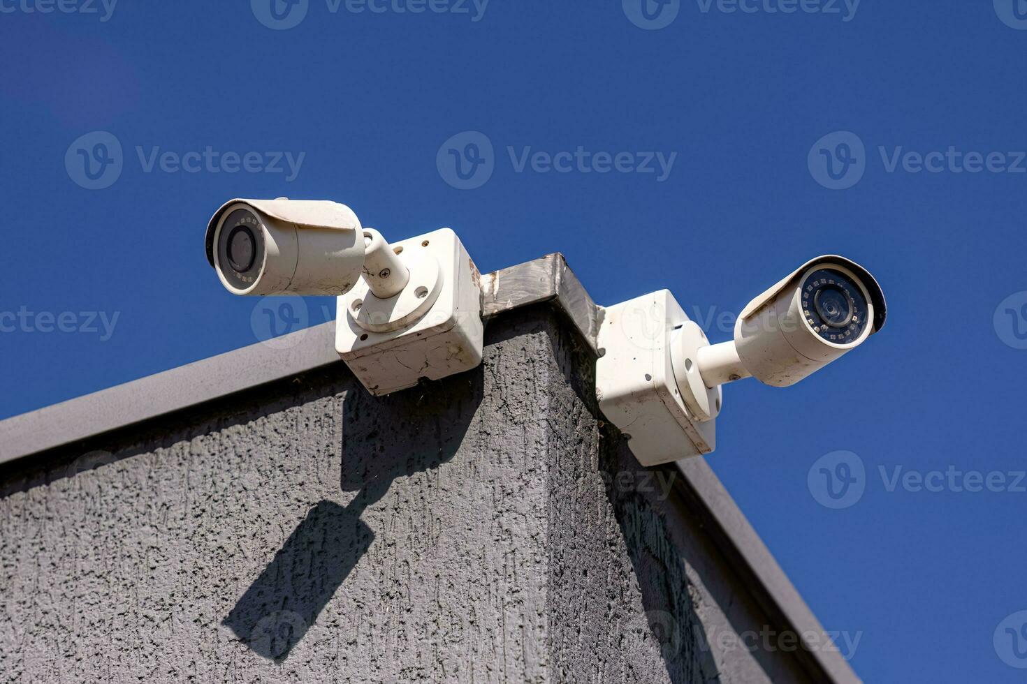 two white security cameras photo