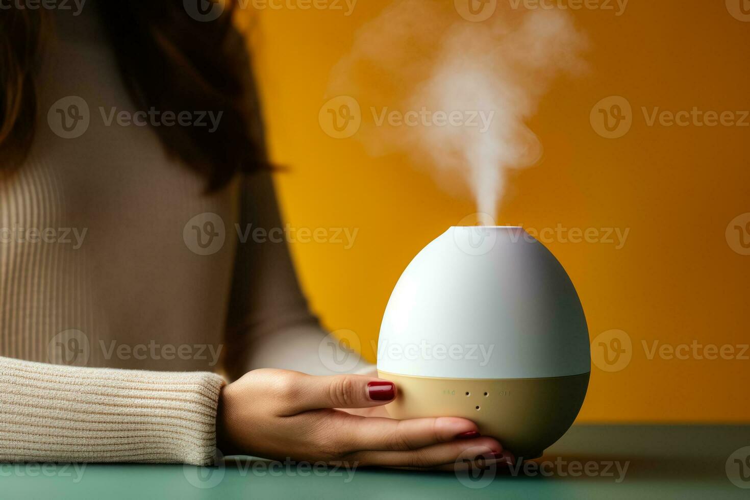 Person using essential oil diffuser during autumn cold isolated on a gradient background photo