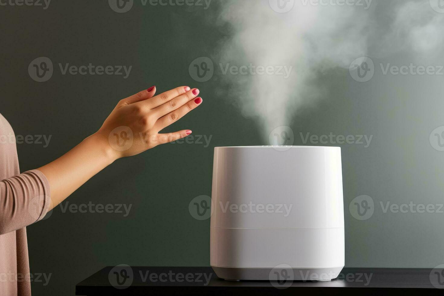 Person adjusting room humidifier during autumn cold isolated on a gradient background photo