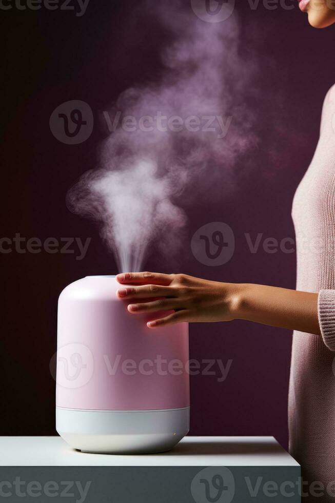 Person adjusting room humidifier during autumn cold isolated on a gradient background photo