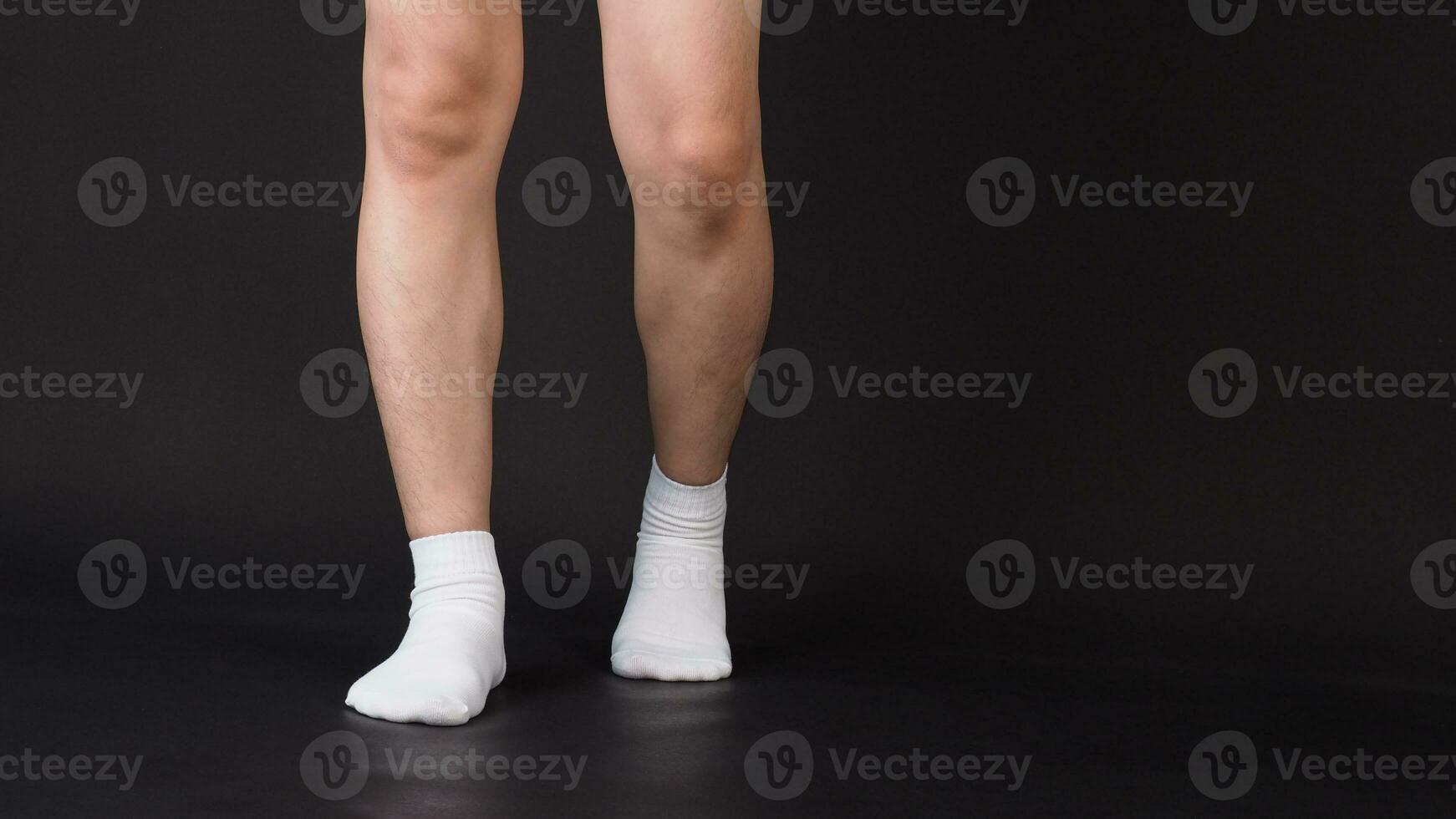 Asian Male split legs wear white sock is isolated on black background photo