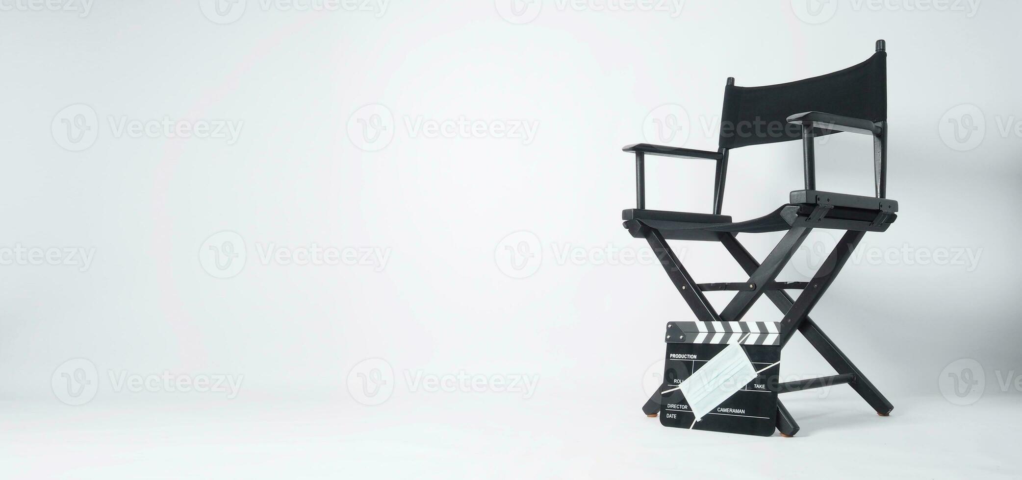 Director chair and black Clapper board or movie slate with face mask. it use in video production and cinema industry on white background. photo