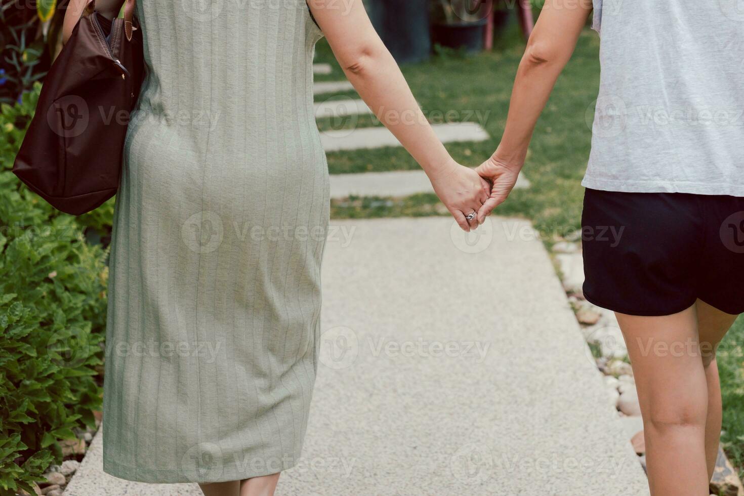 LGBTQ couple walking with hand holding hands. photo