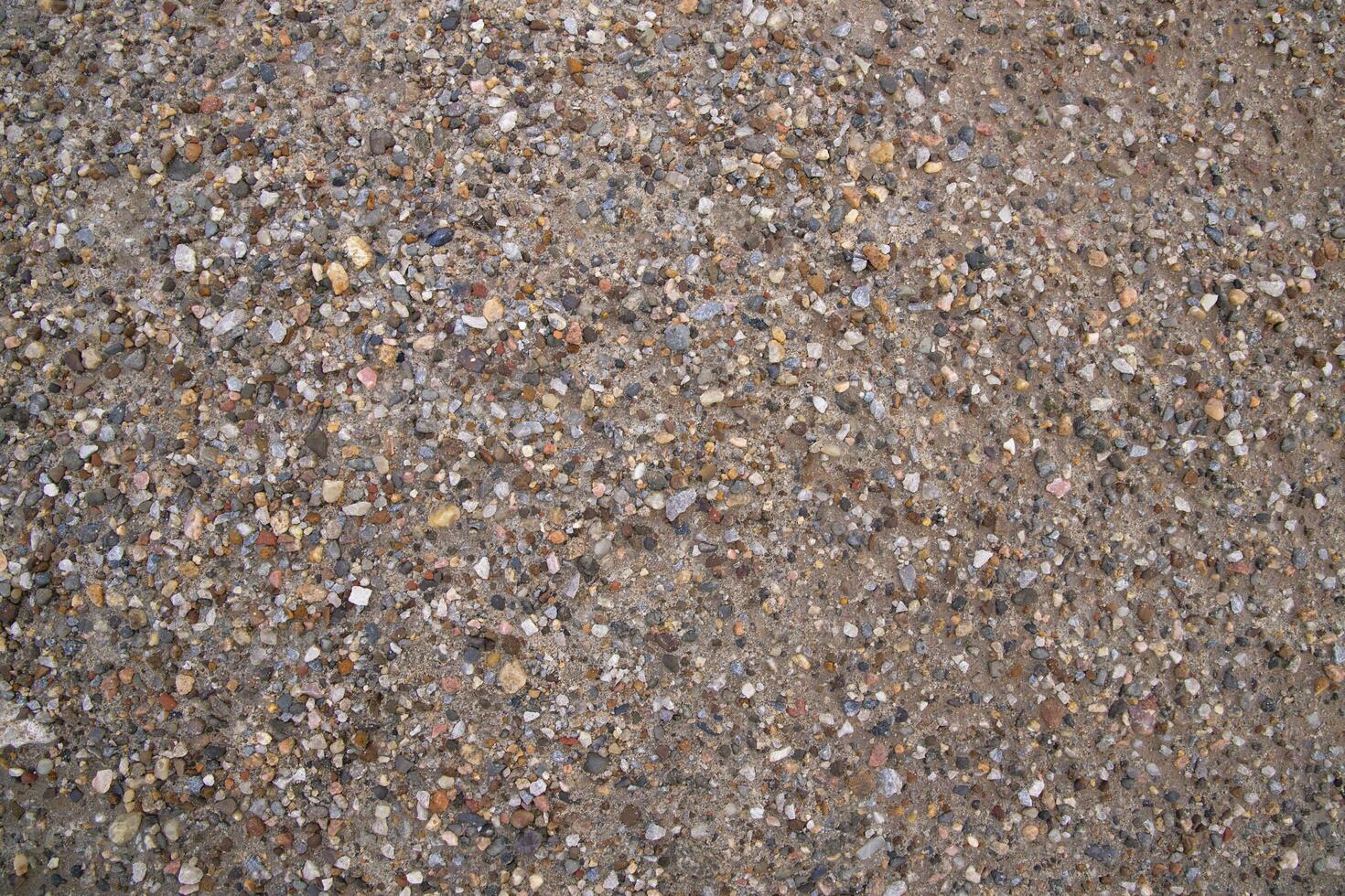 Background texture of small pebbles on the surface of the road photo