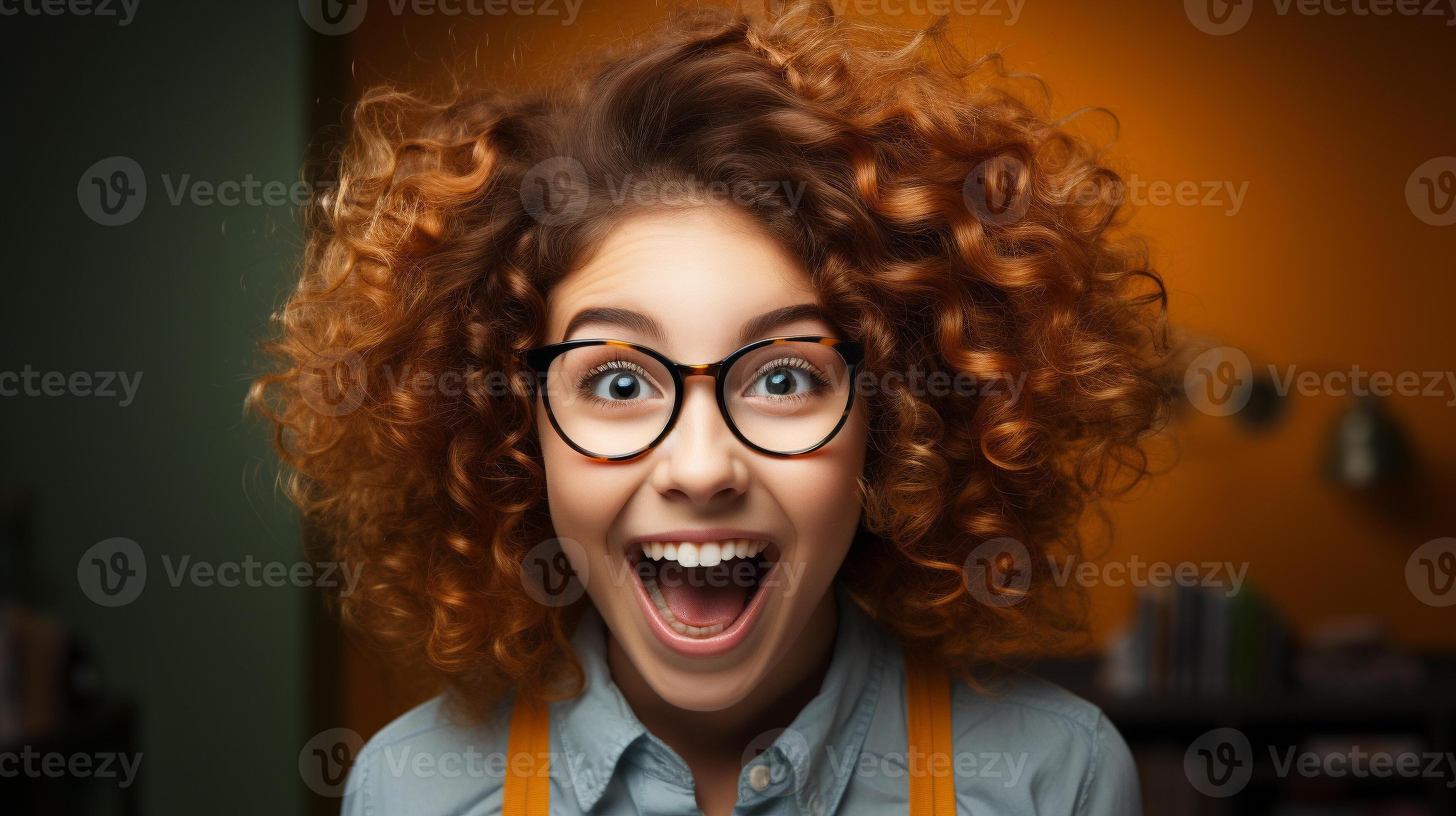 Deliriously happy and excited young adult girl wearing glasses smiling