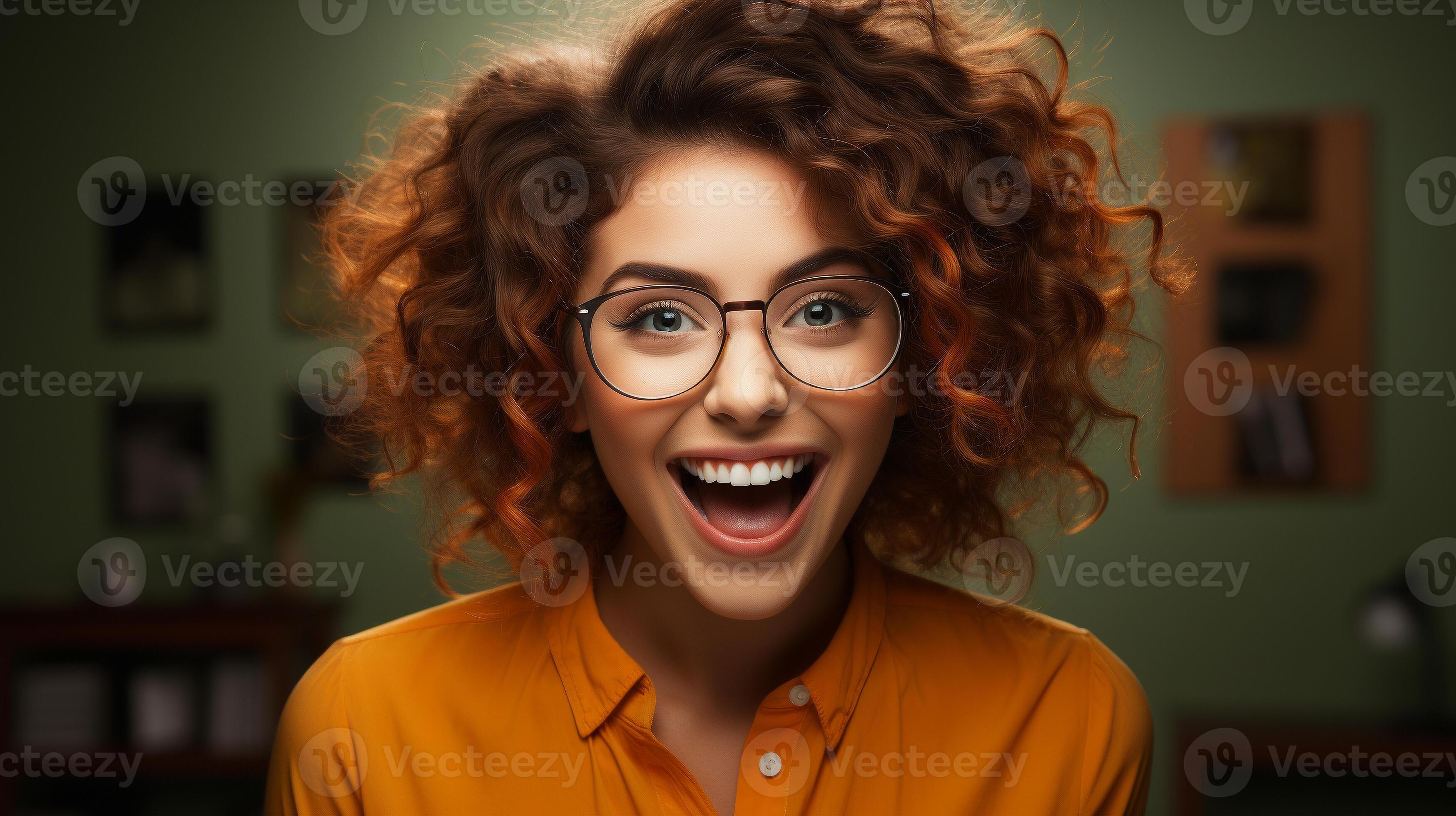Deliriously happy and excited young adult girl wearing glasses smiling