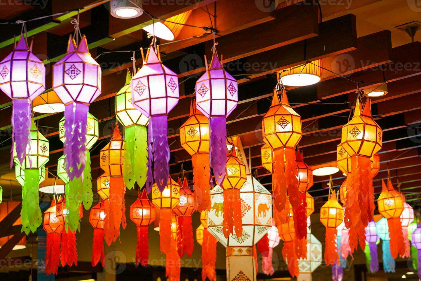 Closeup Colorful perspective view of Thai Lanna style lanterns to hanging on the ceiling and turn on light at night. photo