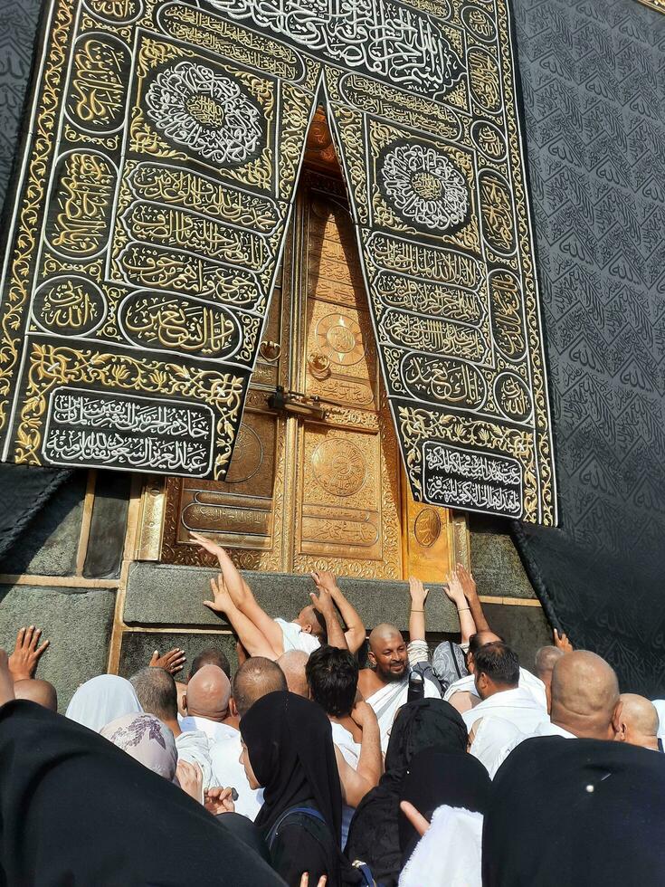 Mecca, Saudi Arabia, Aug 2023 -  Pilgrims from all over the world gather near the door of the Kaaba in Masjid Al Haram. photo