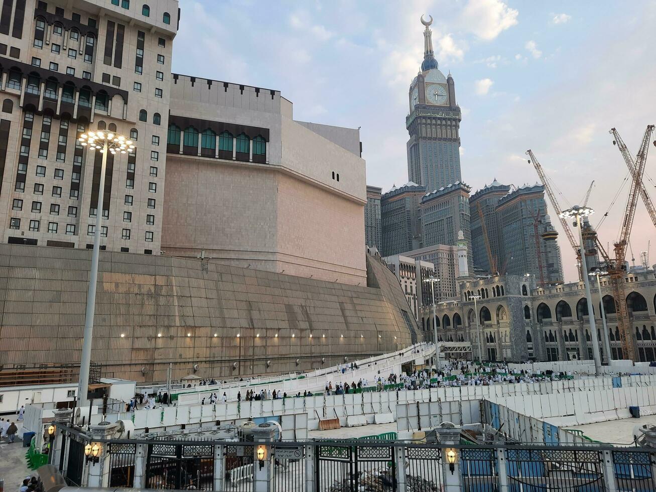 Mecca, Saudi Arabia, Sep 2023 - A beautiful view of the Makkah Royal Clock Tower at sunset. Pilgrims from all over the world are busy preparing for Maghrib prayers. photo