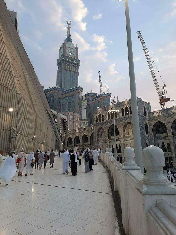 Mecca, Saudi Arabia, Sep 2023 - A beautiful view of the Makkah Royal Clock Tower at sunset. Pilgrims from all over the world are busy preparing for Maghrib prayers. photo