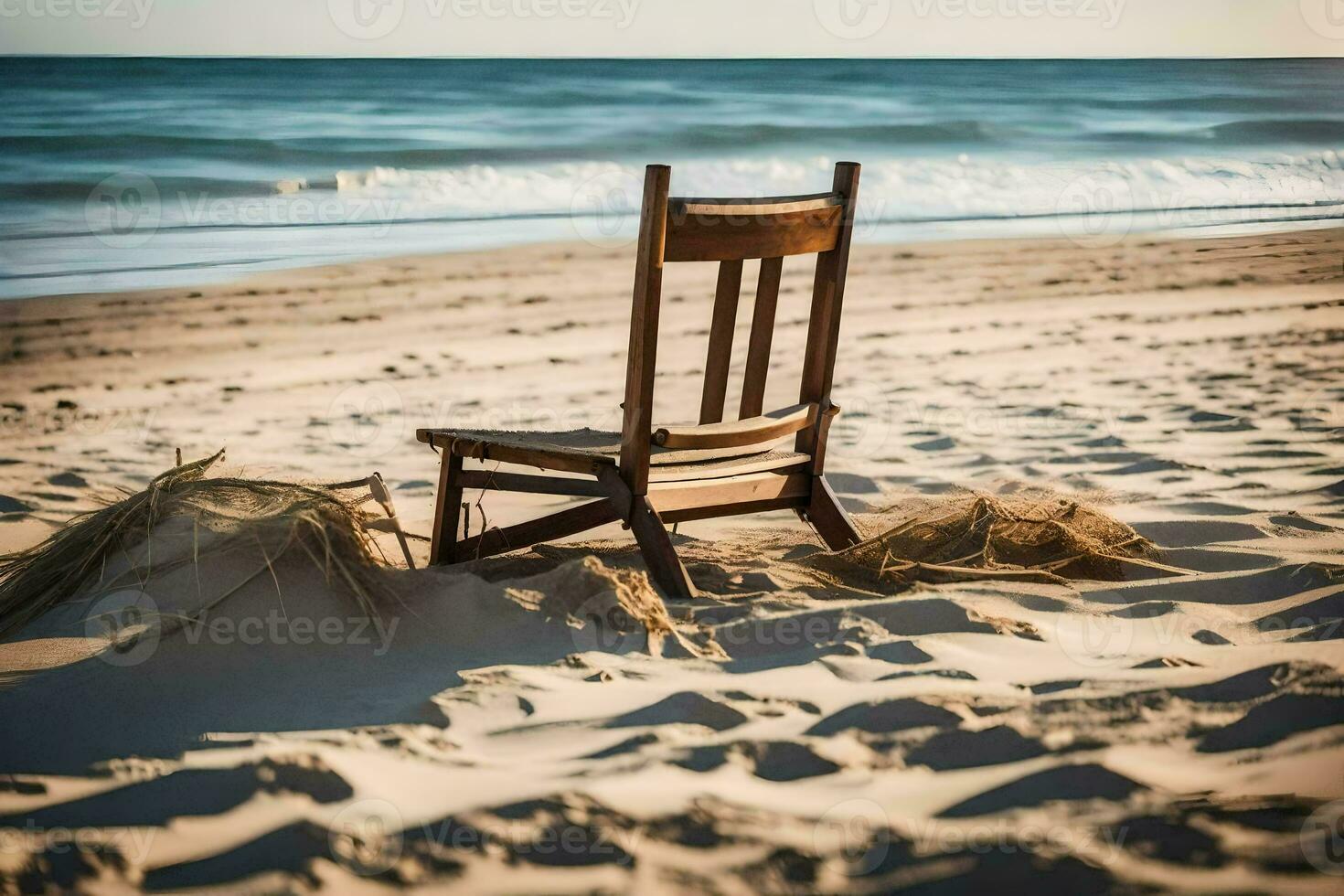 a chair sits on the beach near the ocean. AI-Generated photo
