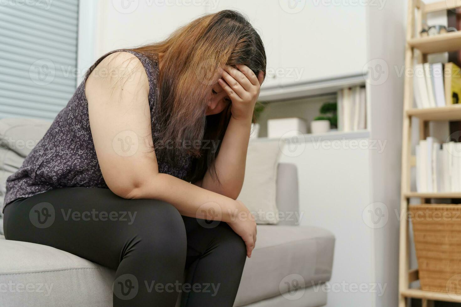 Sad Overweight plus size woman thinking about problems on sofa upset girl feeling lonely and sad from bad relationship or Depressed woman disorder mental health photo