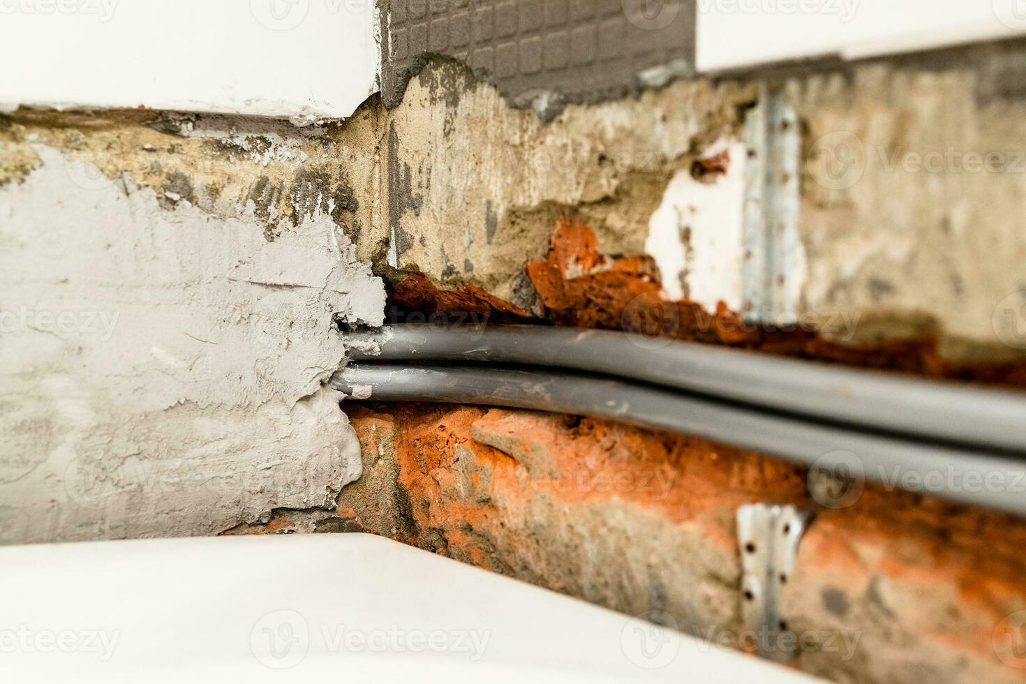 installation of plumbing pipes in chiseled wall photo