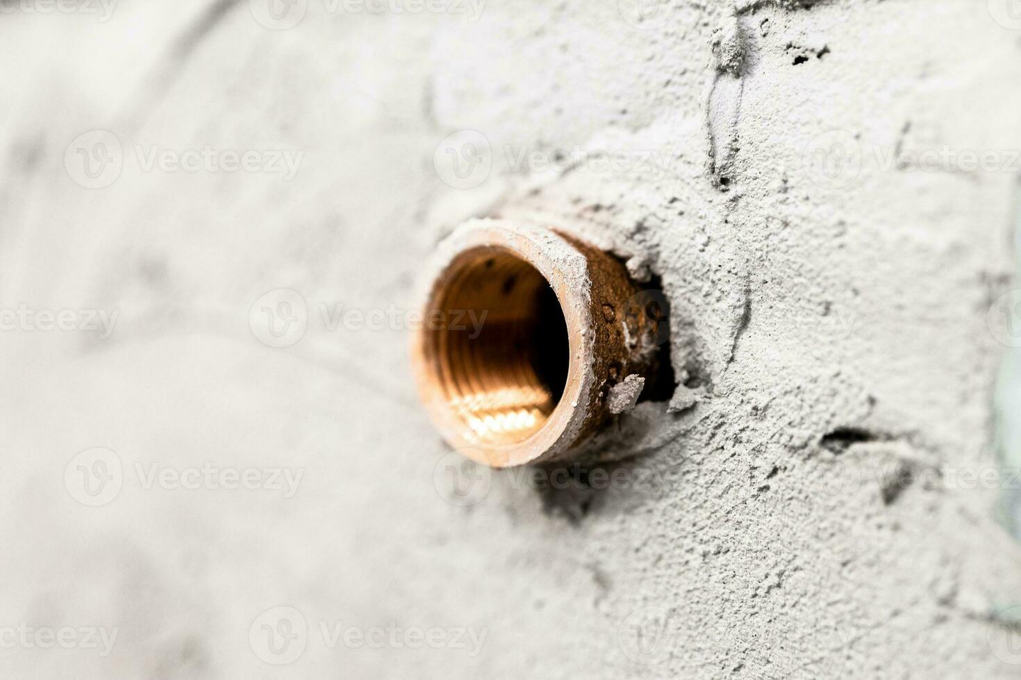 installed and plastered faucet eccentric close up photo