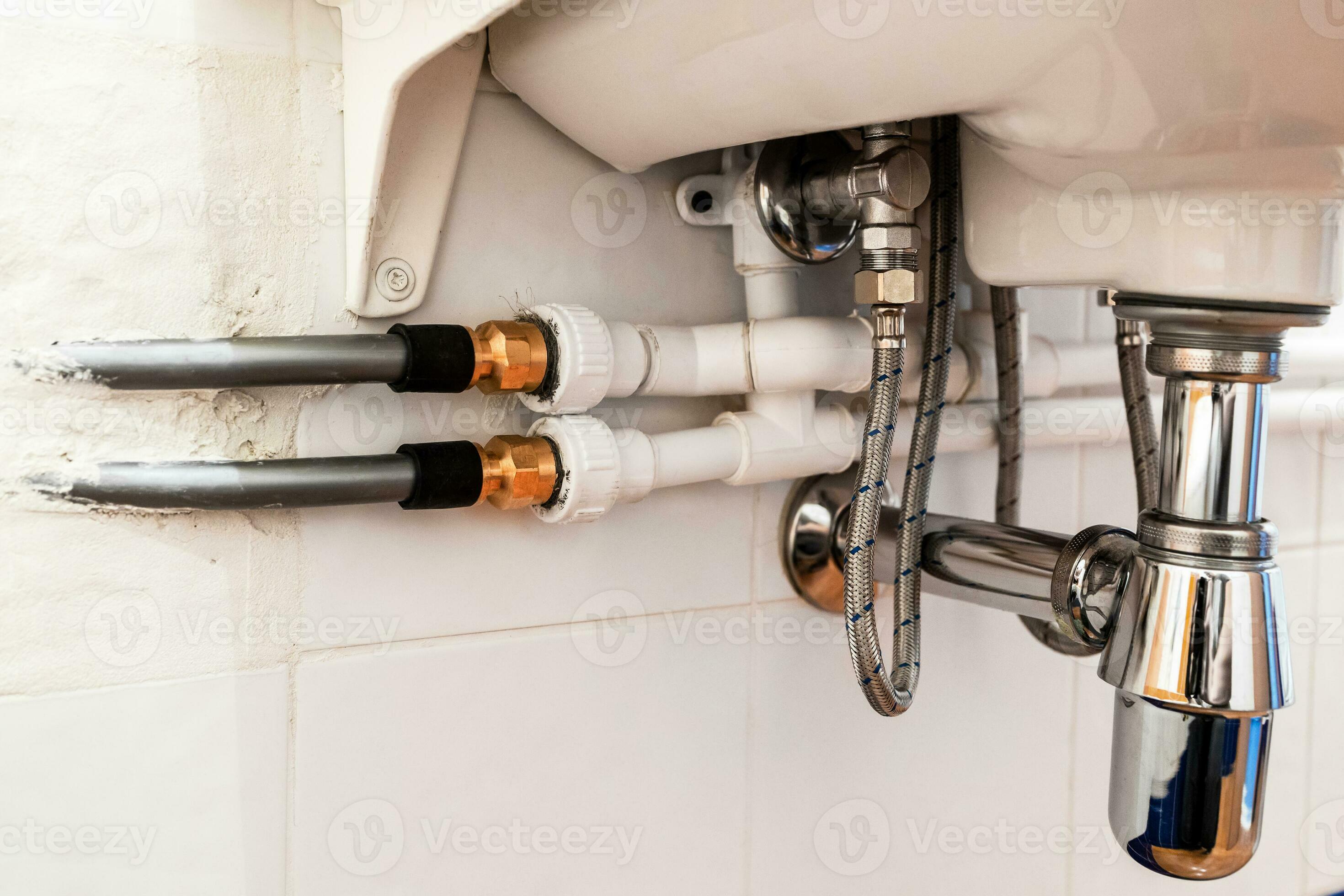 connection of various pipes under sink in bathroom 30192240 Stock Photo