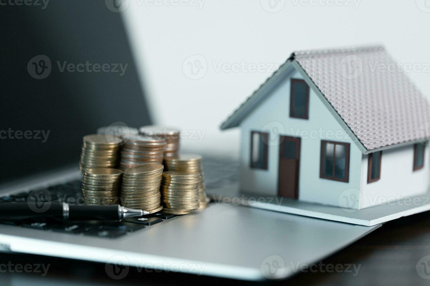 Business loans for real estate concept, money with model home on the table on office background. photo