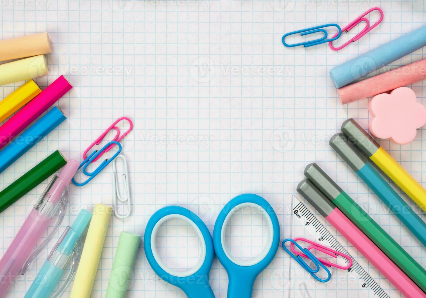 School stationery lie on a white notebook sheet in the form of a frame. Top view. Copy space. Mockup. Back to school. Copy space. photo