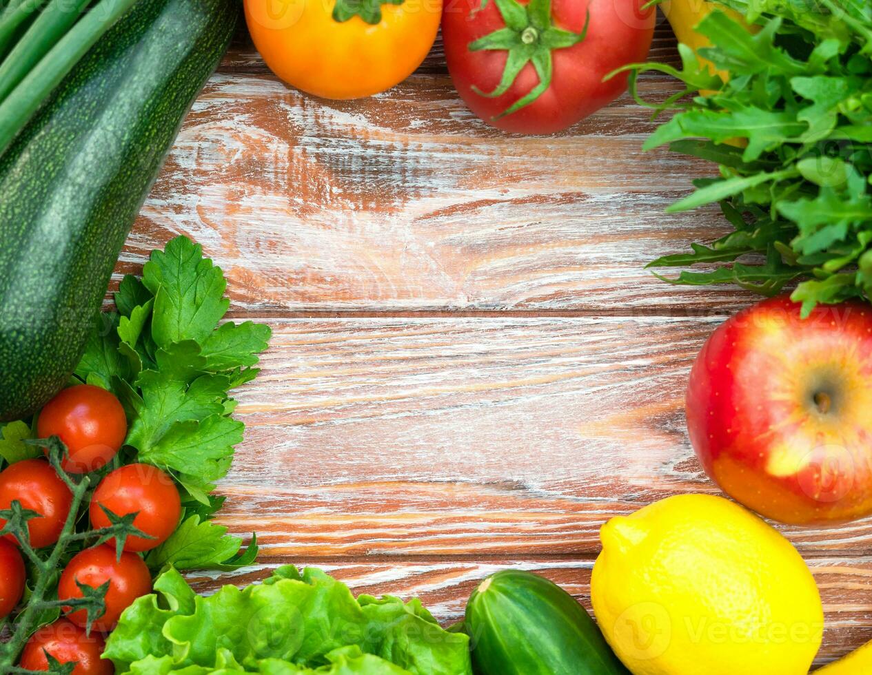 Frame of fresh healthy vegetables and fruits on wooden background. Healthy food concept. Top view. Copy space. photo