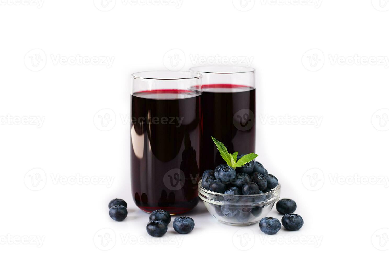 Fresh natural blueberry juice in glasses isolated on white background. Close-up. Copy space. photo