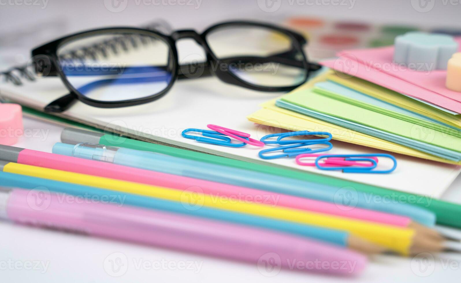 Teacher's Day. Glasses and school stationery on the table. Back to school. Close-up. Selective focus. photo