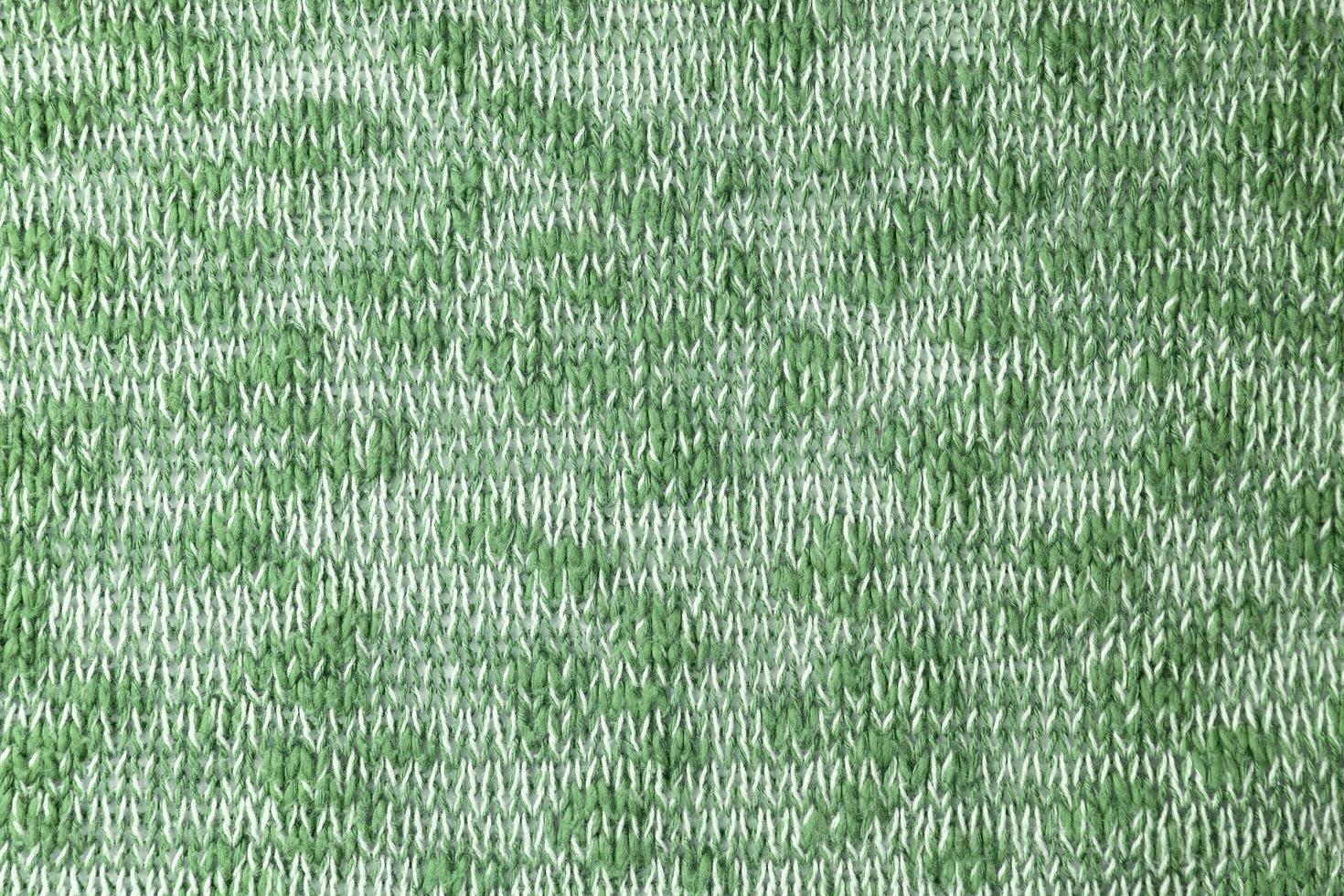 Bright green white melange knitwear wool fabric texture background. Abstract textile backdrop photo
