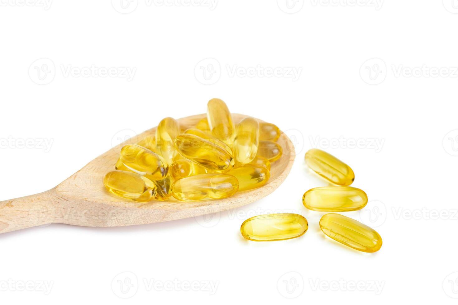 Pile of capsules Omega 3 in wooden spoon isolated on white background photo