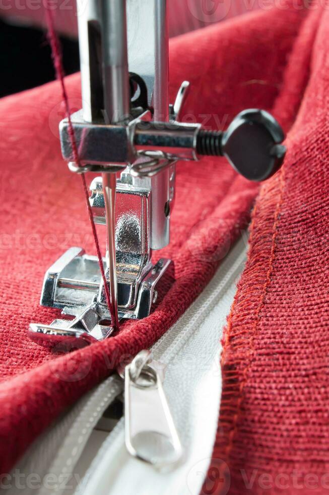 Modern sewing machine presser foot and zipper. Sewing process photo