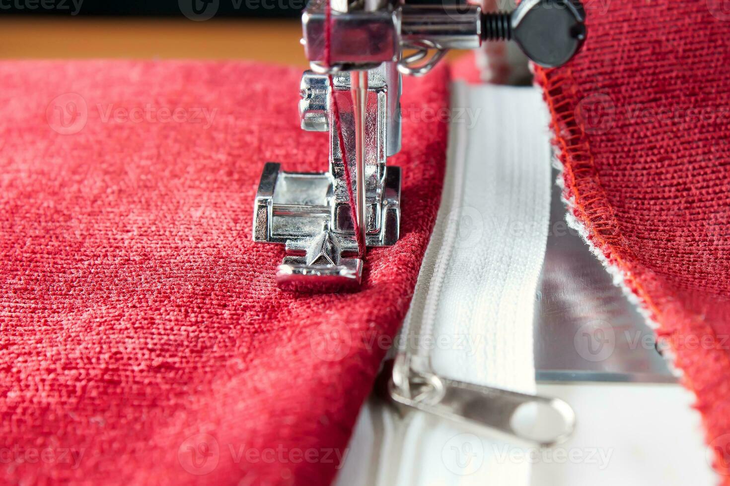 Modern sewing machine presser foot and zipper. Sewing process photo
