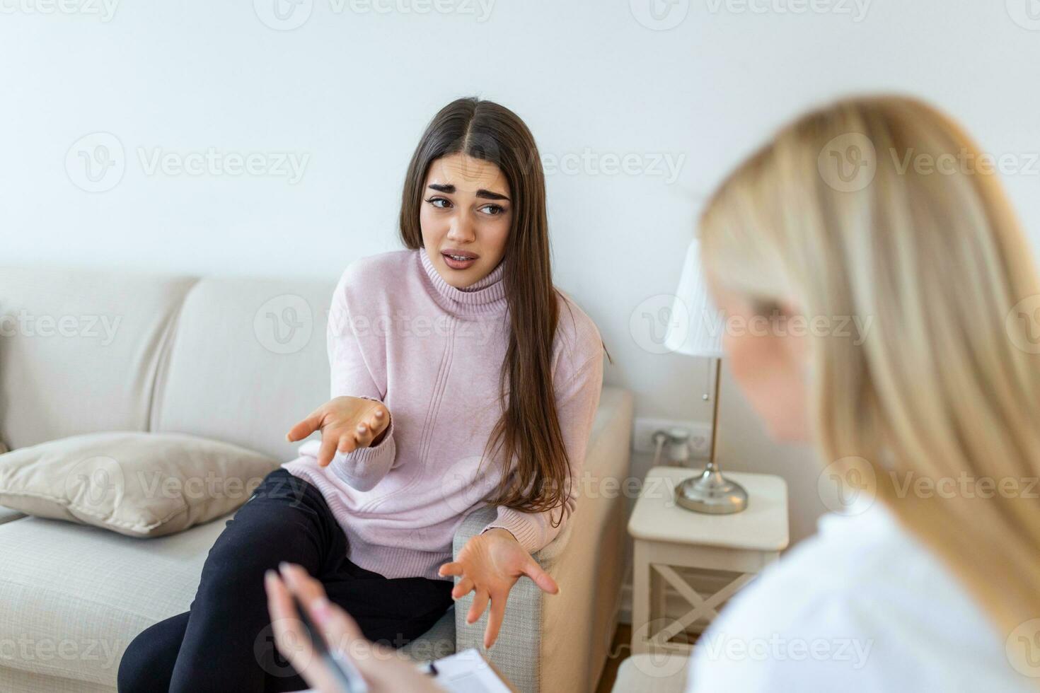 Psychologist listening to her patient and writing notes, mental health and counseling. Psychologist consulting and psychological therapy session concept photo