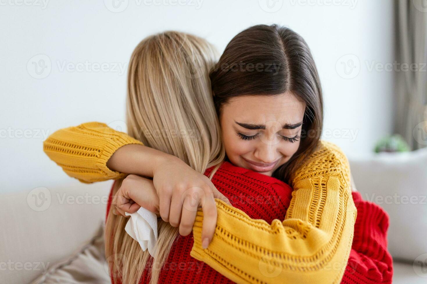 Condolence and support concept. Caring woman hugging her crying girlfriend, comforting her after receiving bad news photo