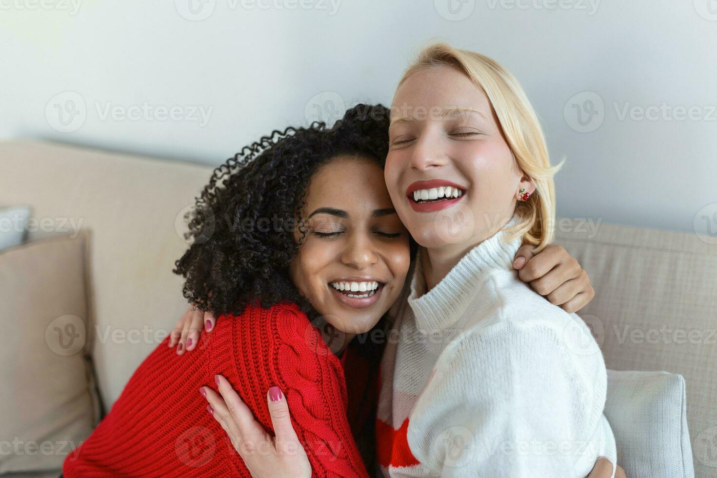 Candid diverse girls best friends embracing standing indoors, close up satisfied women face enjoy tender moment missed glad to see each other after long separation, friendship warm relations concept photo