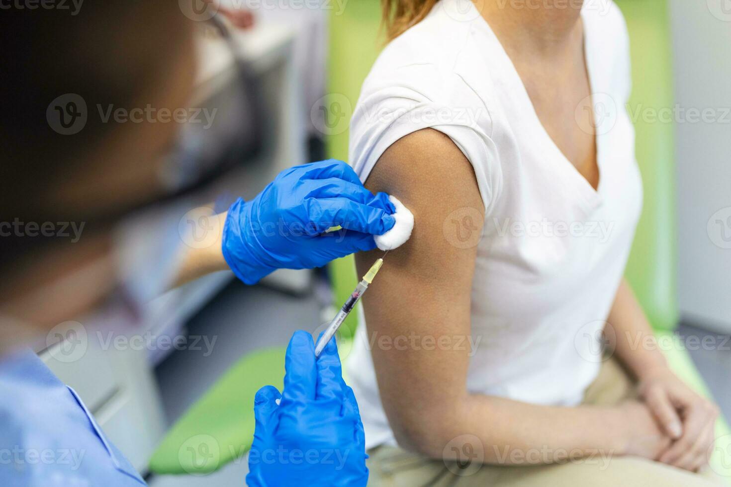 Covid-19 Vaccination. Patient Getting Vaccinated Against Coronavirus Receiving Covid Vaccine Intramuscular Injection During Doctor's Appointment In Hospital. Corona Virus Immunization photo