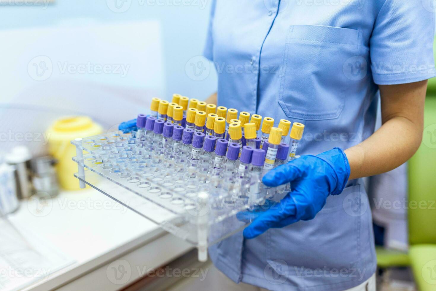Technician holding blood tube test in the research laboratory. Coronavirus testing. Doctor taking a blood sample tube from a rack in the lab photo