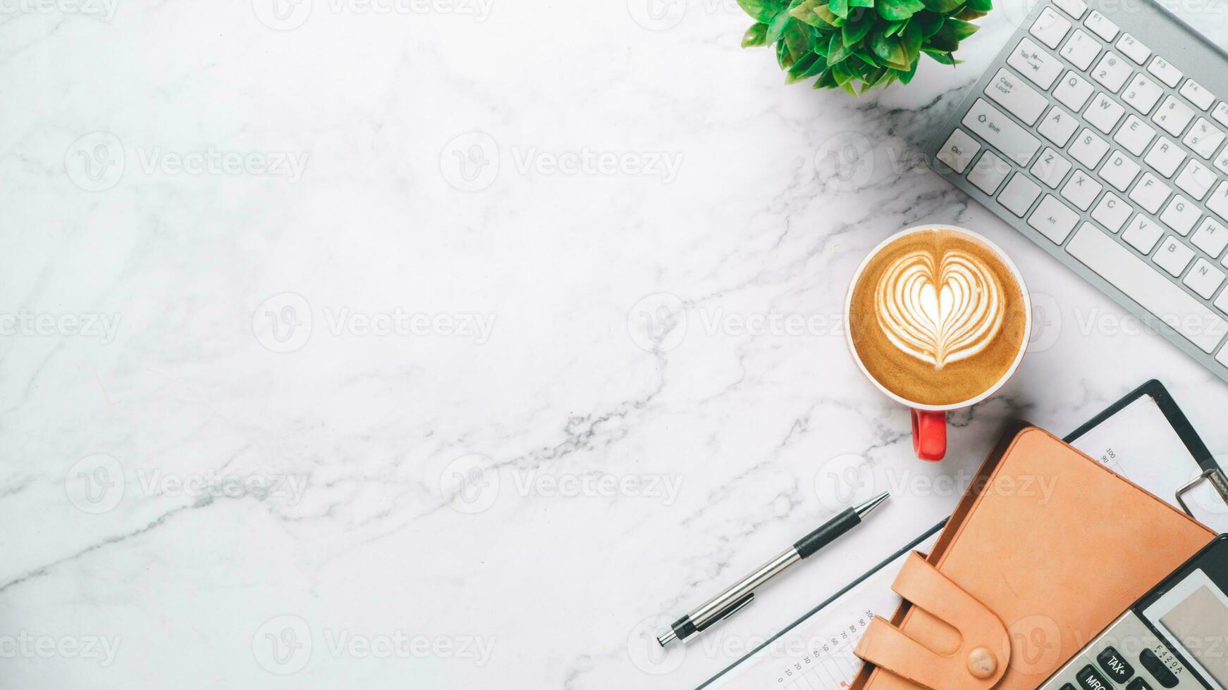 Office desk table with analysis chart or graph, pen, cup of coffee, notebook and calculator on white background. Top view with copy space. Working desk table concept. photo