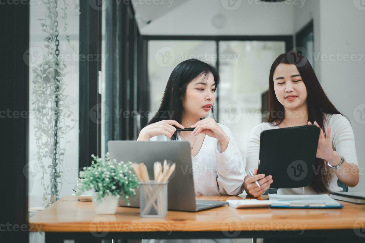 Business woman talking to her colleague during a meeting in a boardroom, Business team working on digital tablet. photo