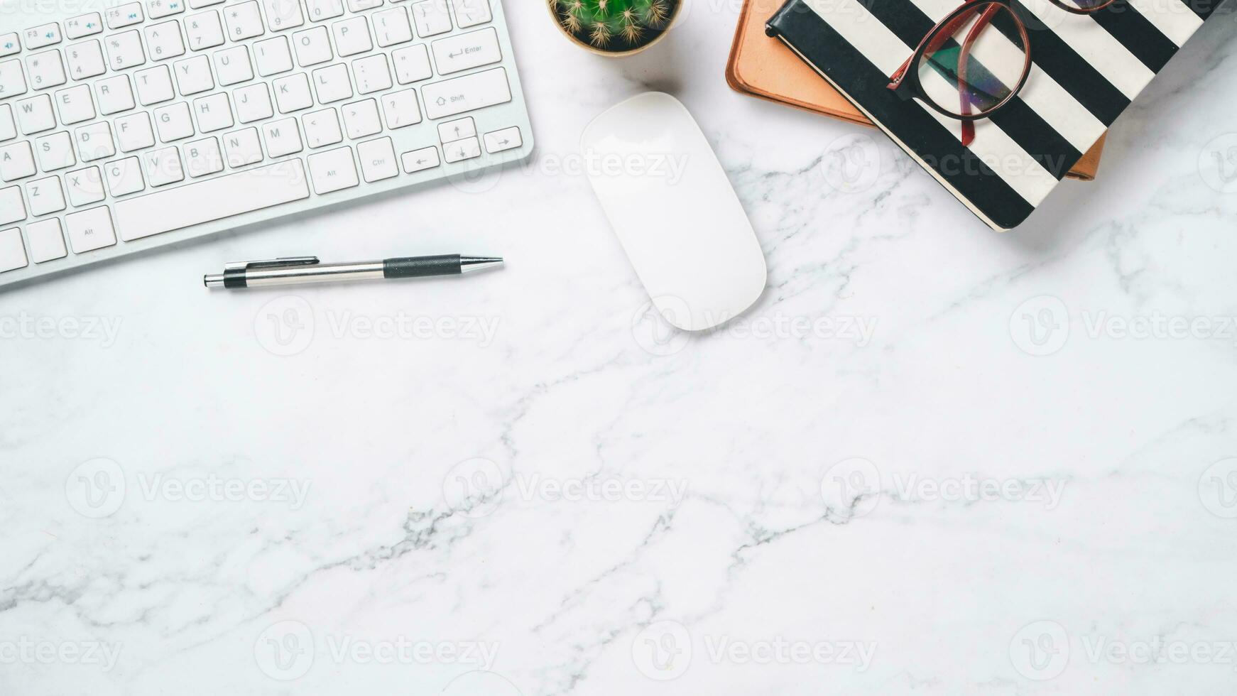 Top view, White office desk with keyboard, notebook, pen, eyeglass and mouse, copy space, Mock up. photo