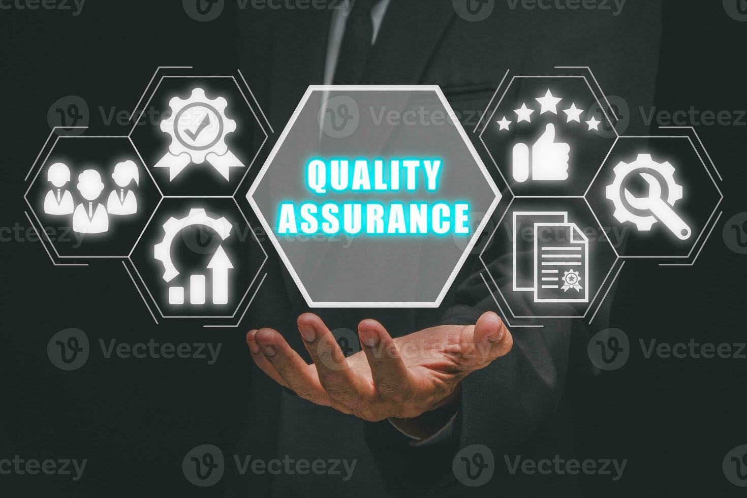 Quality assurance concept, Businessman hand holding quality assurance icon on cirtual screen. photo