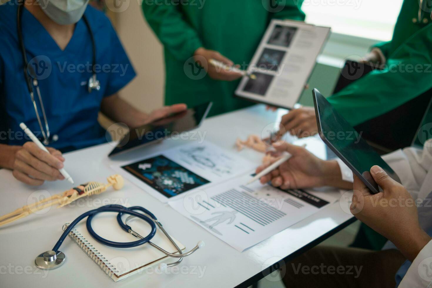 concept of mobilizing ability of medical team in conference room to diagnose and treat disease correctly. medical team joins meeting and discusses  patient illness in order to treat it correctly photo