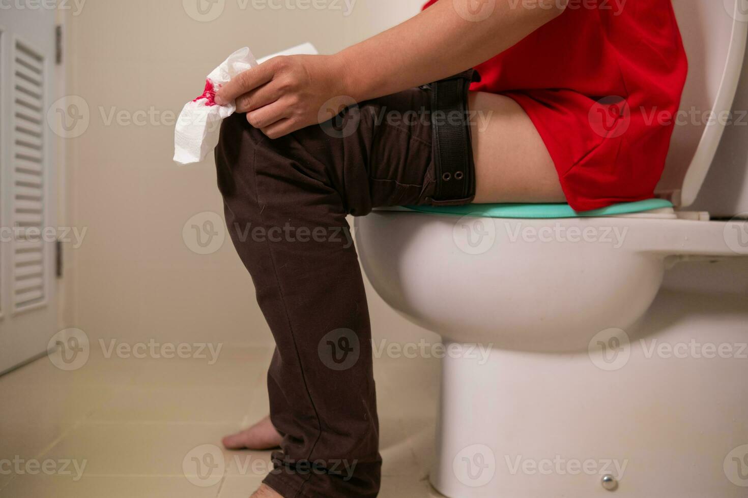 man has hemorrhoids that have worsened and enlarged, and hemorrhoids are severely inflamed, causing bleeding when defecation, infection, weakness and fainting. Inflammatory hemorrhoids pain concept photo