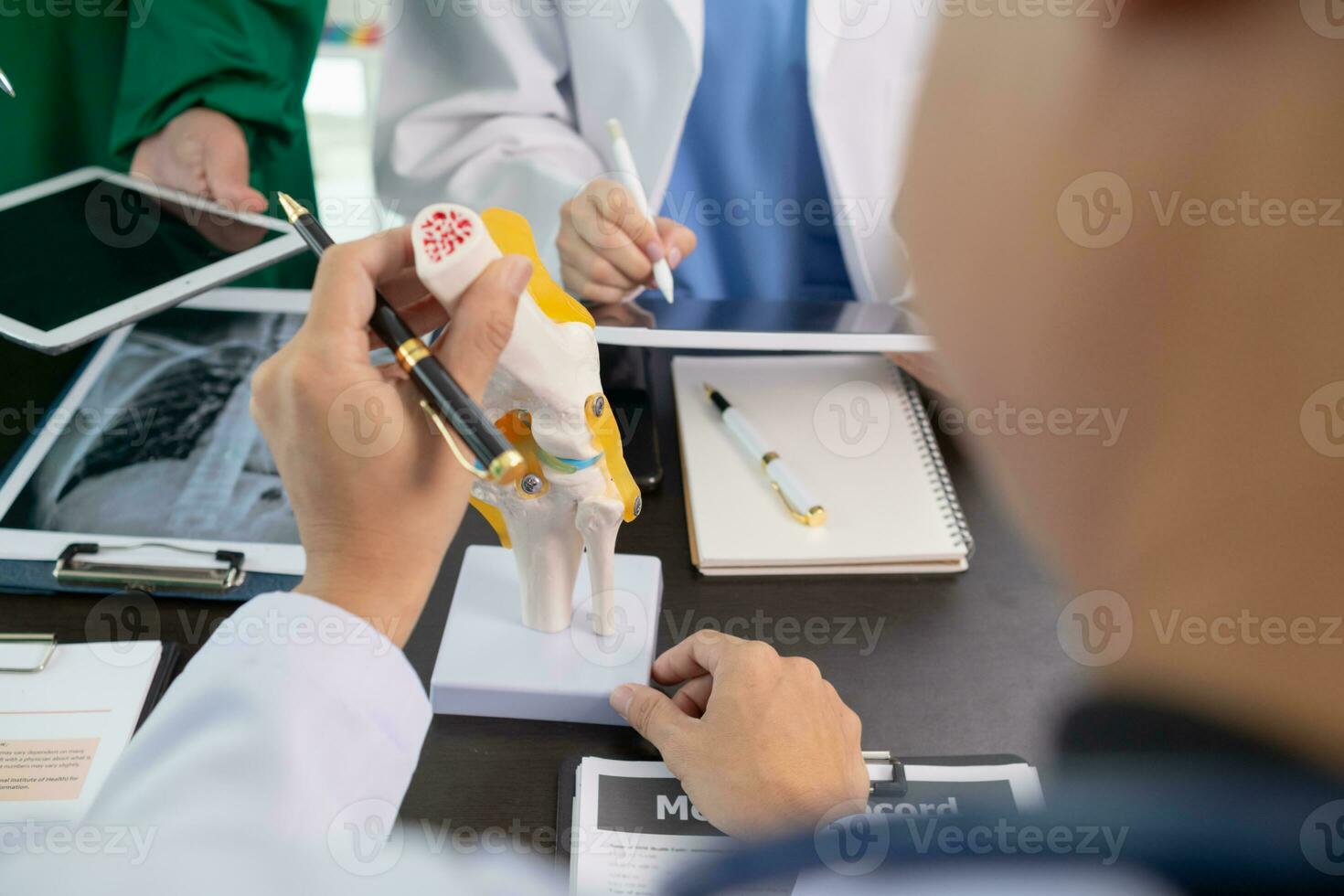 The doctor joins a meeting with the surgeon's team to discuss a plan for cancer surgery after the medical team detects cancer. Collaborative concept of a team of doctors and surgeons in surgery. photo