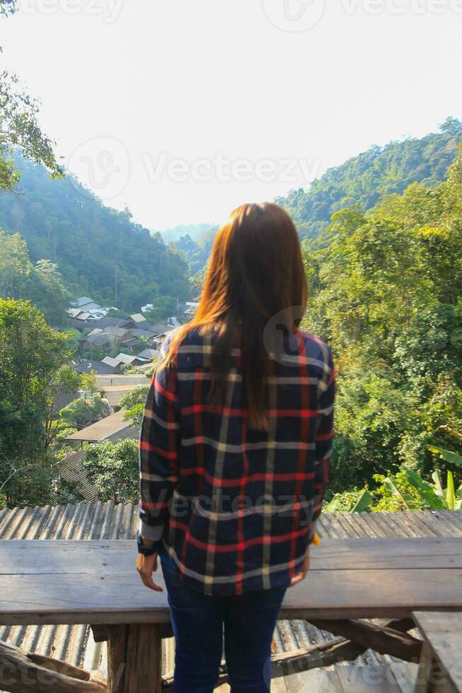 Back scene of woman alone with feeling lonely and depressed on blurred background of beautiful nature scenery . concept of woman who had to be alone in past was depressed when she encountered problems photo