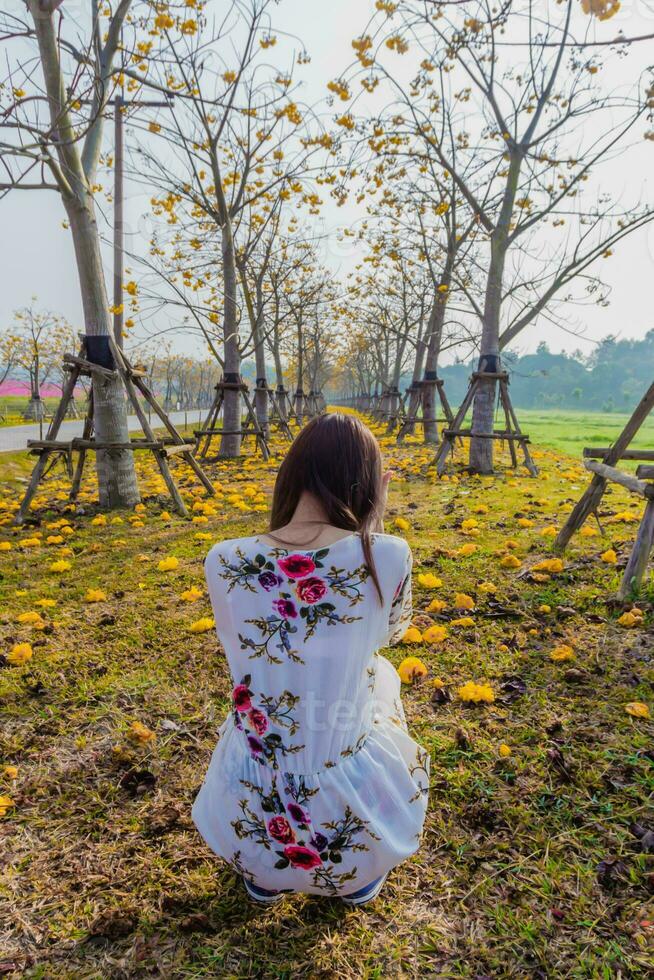 young woman blessed the view of flower garden that looks beautiful in summer alone. Young woman tourists admiring beauty of summer scenery and beautiful flower gardens Copy Space for text photo