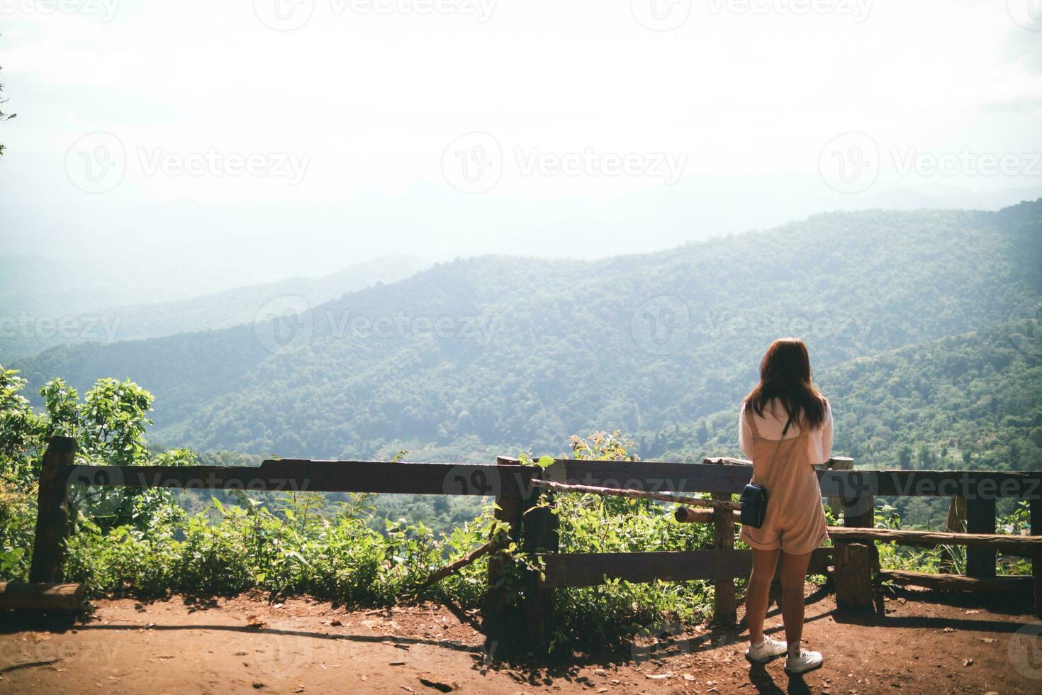 Back scene of woman alone with feeling lonely and depressed on blurred background of beautiful nature scenery . concept of woman who had to be alone in past was depressed when she encountered problems photo