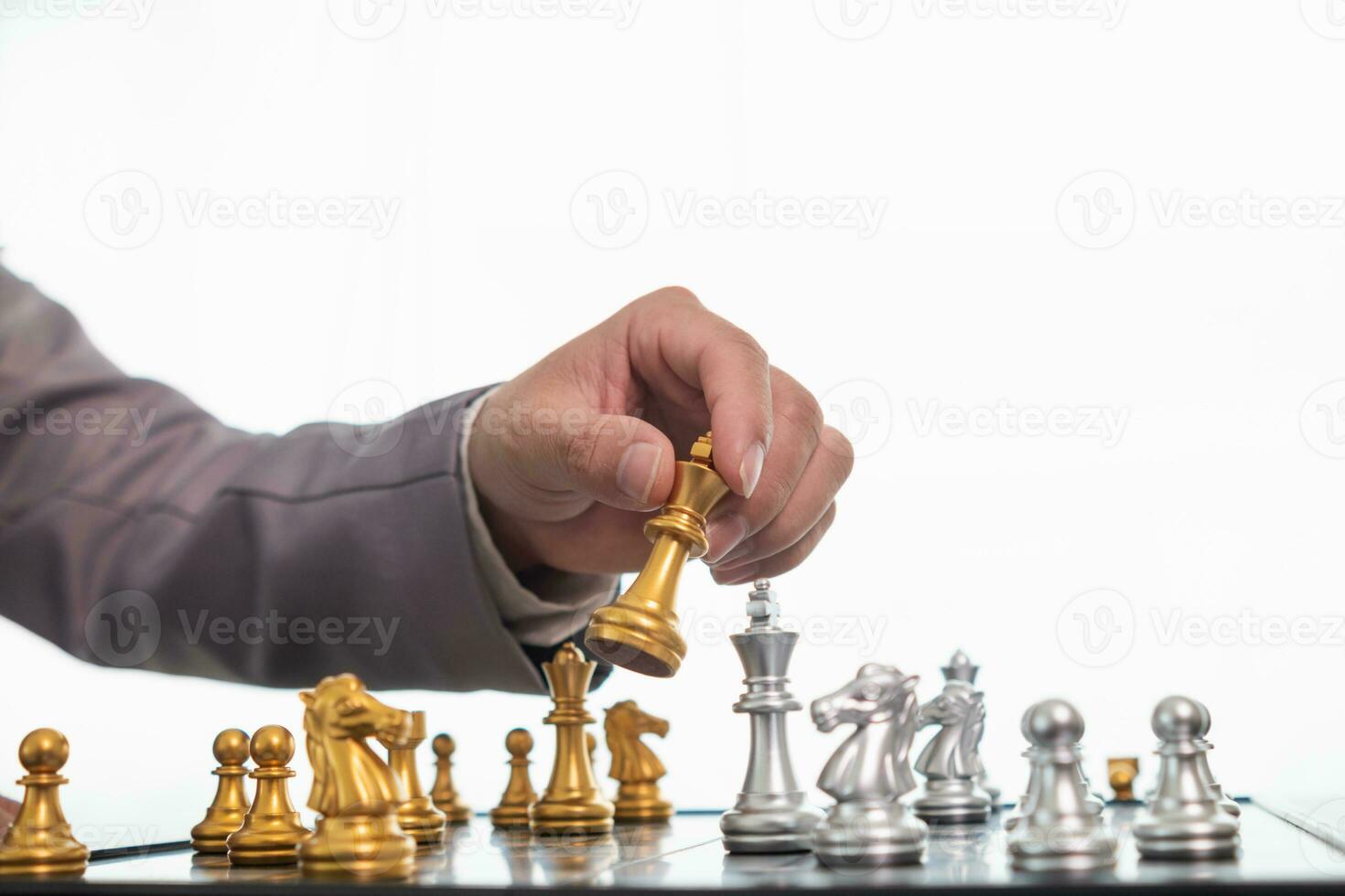 Young businessman planning winning chess move in game of chess representing successful and victorious business path. chess concept representing strategic business strategy to achieve victory. photo